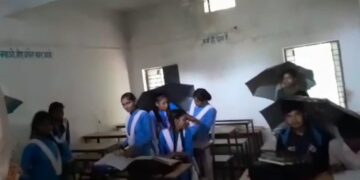 Students seen studying holding umbrellas as water drips from govt school ceiling in Shahdol