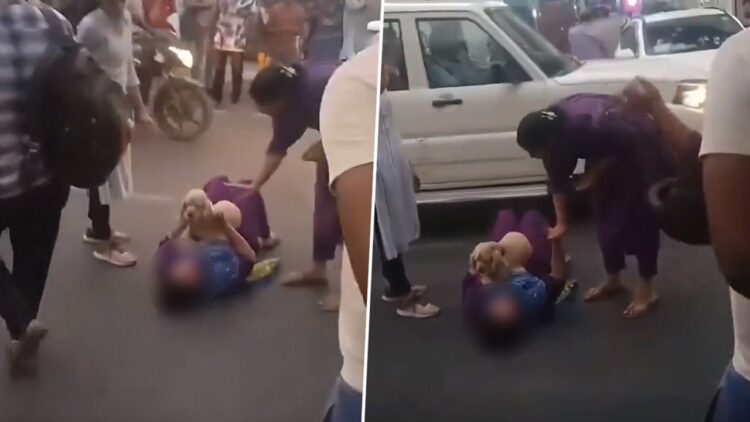 Woman lies down on road